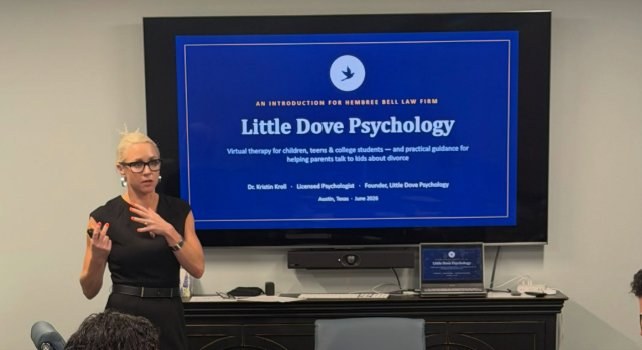Dr. Kristin Kroll presenting to Hembree Bell Law Firm, with a Little Dove Psychology title slide on screen behind her.